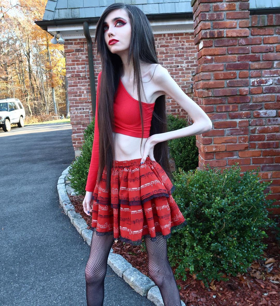 Skinny YouTuber Eugenia Cooney models for. outside of her own house. 